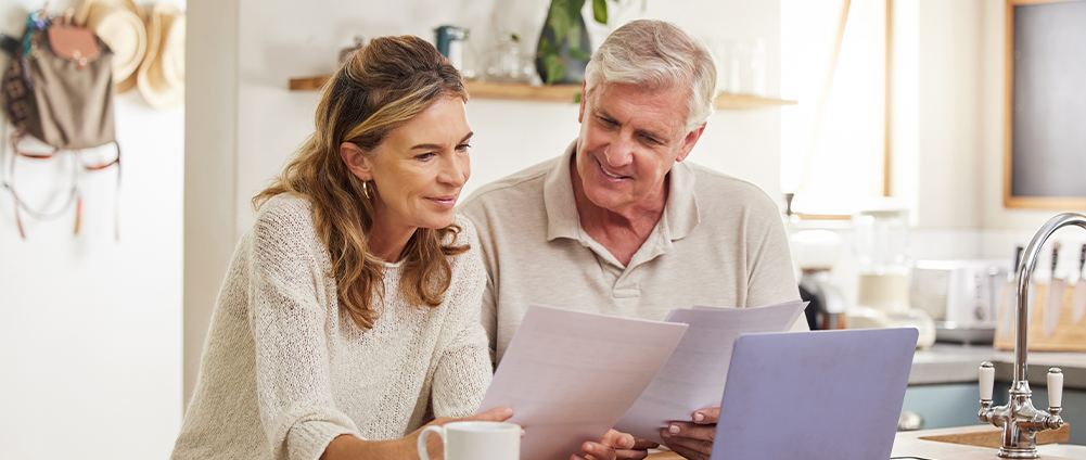 Military Veteran and spouse analyzing their finances. Essential financial steps for Veterans in their 50s.