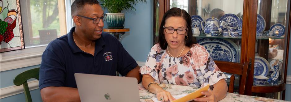 man and woman looking at the laptop