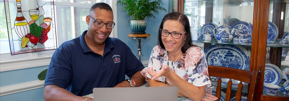 man and woman looking at computer