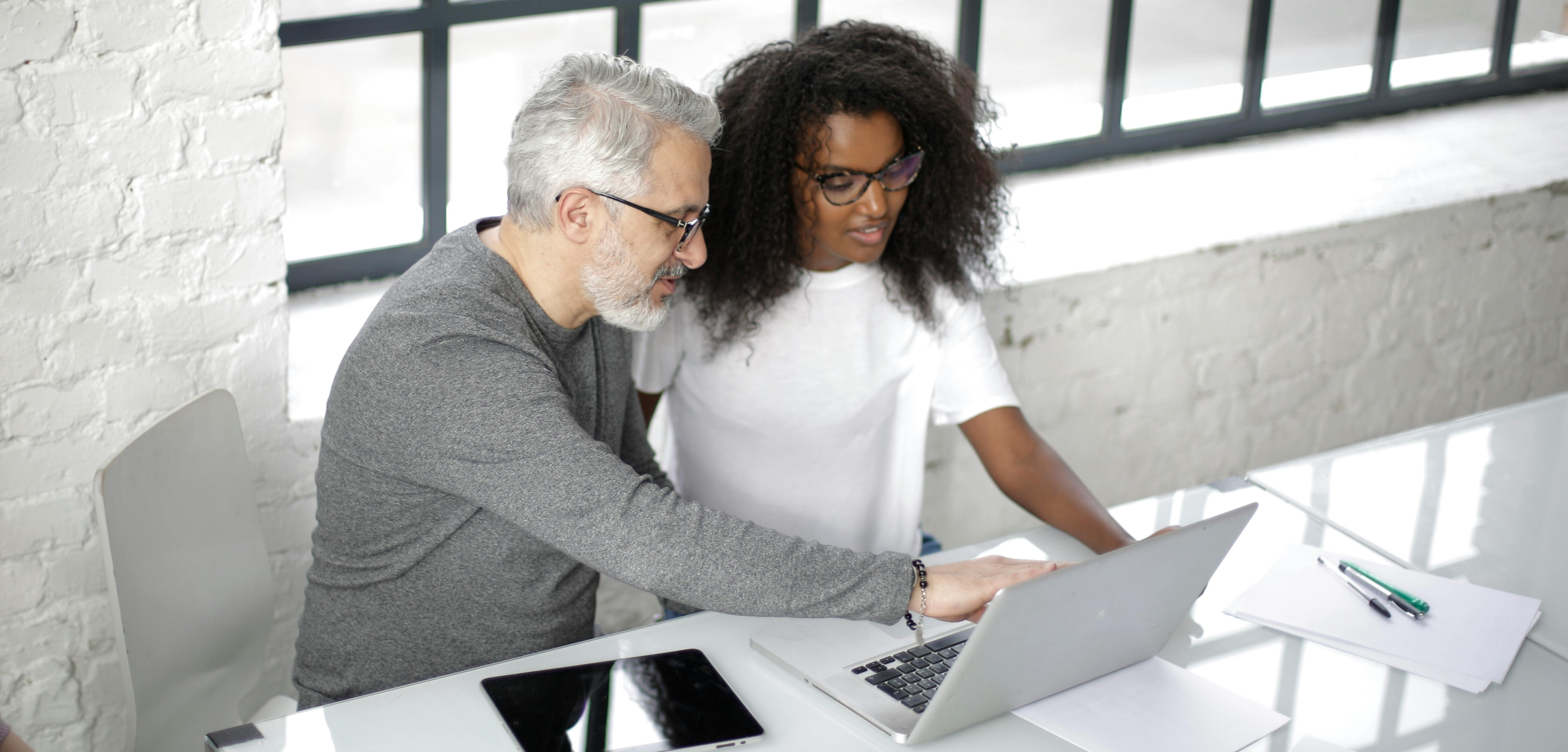 Veteran couple looking up Trusts from AWM&T on their laptop.