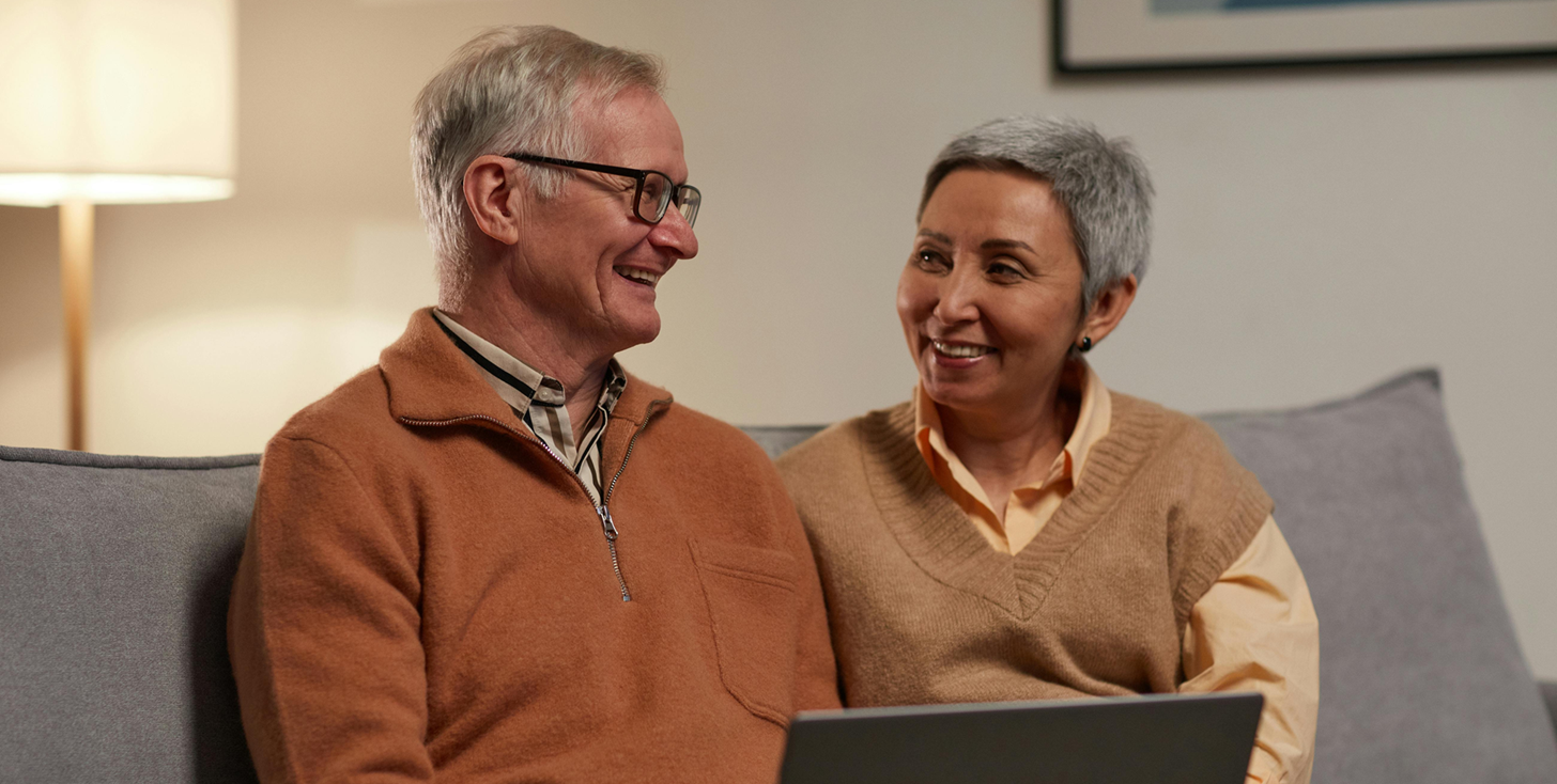Veteran couple reading the AWM&T 2026 IRA Disclosures.