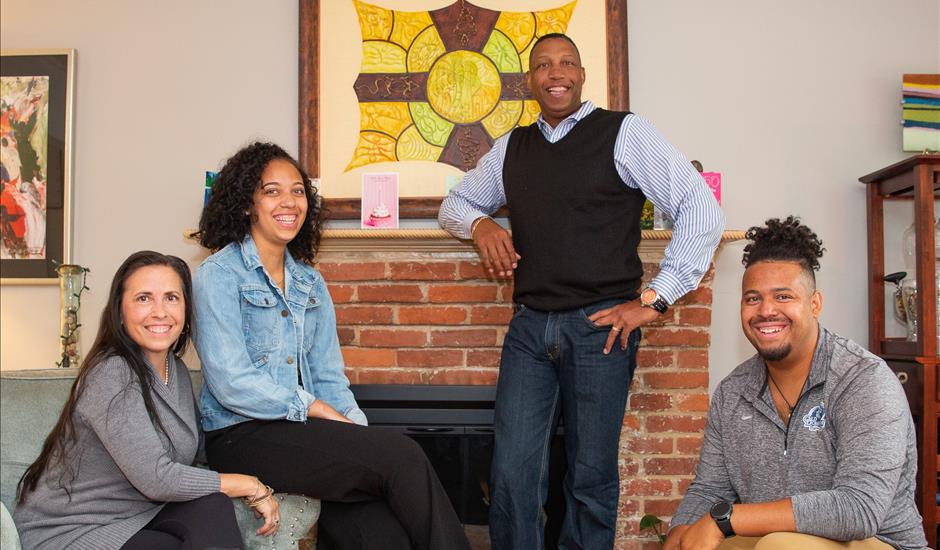 family standing in front of fireplace