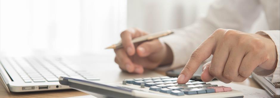 Someone typing on a computer to engage in military financial planning with AAFMAA Wealth Management & Trust LLC.