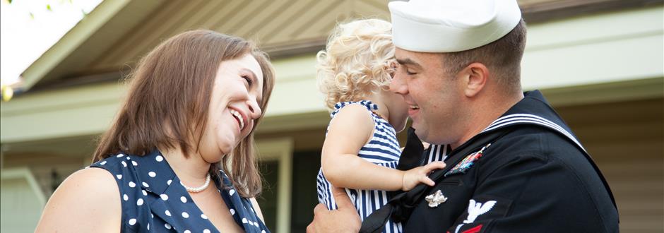 military man smiling at family