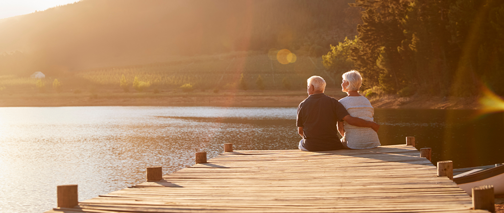 Where Will You Live as You Age? Military discusses while sitting on a dock.