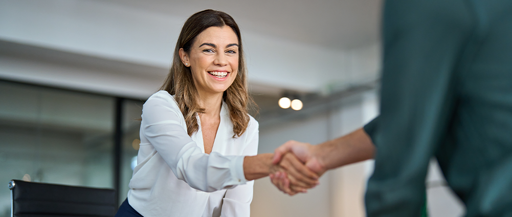Veteran shaking hands with an AAFMAA Wealth Management & Trust LLC (AWM&T) employee.